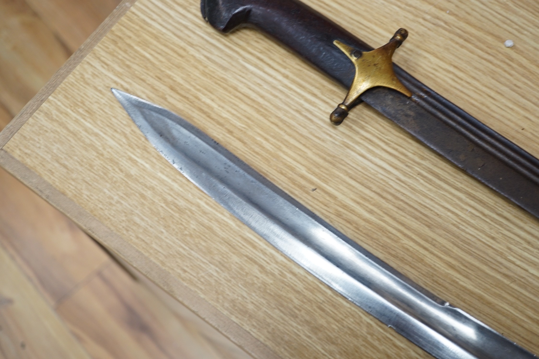 An Ottoman tulwar sabre, a European sabre and a leather whip
